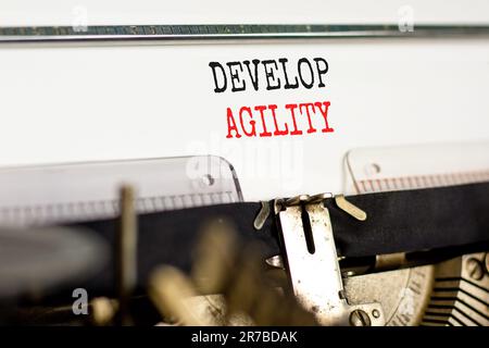 Develop agility symbol. Concept words Develop agility typed on beautiful old retro typewriter. Beautiful white background. Business, support and devel Stock Photo