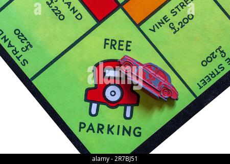 Free Parking with red car token on Vintage Monopoly Property Trading Board Game Trade Mark 711981 Stock Photo