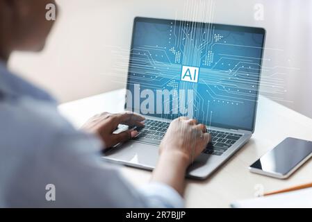 Black woman typing on laptop keyboard, using artificial intelligence Stock Photo