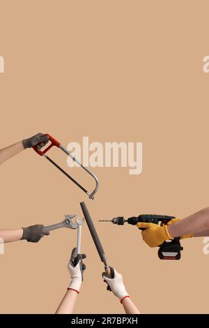 Female and male hands holding different construction tools on beige background Stock Photo
