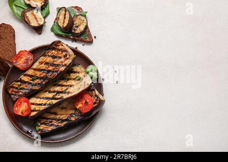 Composition with delicious grilled eggplants on light background Stock Photo