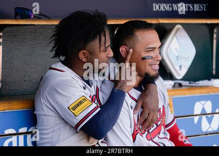 Atlanta Braves' Ozzie Albies, left, and Orlando Arcia (11) joke around in  the dugout in the seventh inning against the Detroit Tigers during the  first baseball game of a doubleheader, Wednesday, June