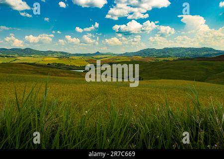 Amazing Tuscany panoramic landscape with green hills in morning, Volterra Stock Photo