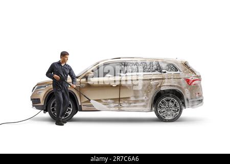 Man in a uniform using a pressure washer and cleaning a SUV isolated on white background Stock Photo