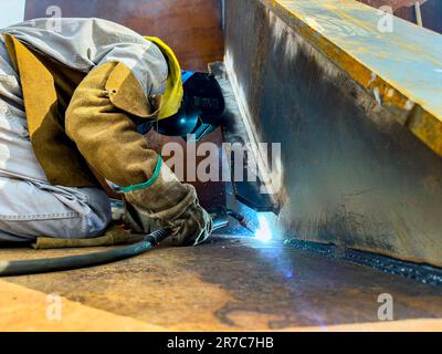 Welder working with an electrode. Stock Photo