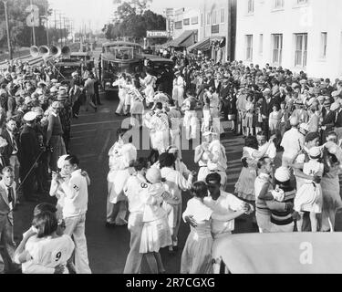 Culver City, California:  1928 The early stages of the marathon dancing endurance contest that started in Culver City and continued eight miles to Ocean Park in Santa Monica. The dancers were accompanied by five motor trucks laden with jazz bands. Stock Photo