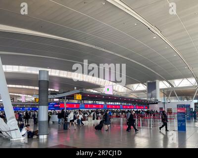 Queens, NY – USA – June 1, 2023 Wide angle view of travelers walking through the Delta Airline’s departure hall at John F. Kennedy International Airpo Stock Photo