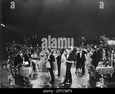United States:  c. 1930 People dancing outdoors at an elegant party in a tropical setting. Stock Photo
