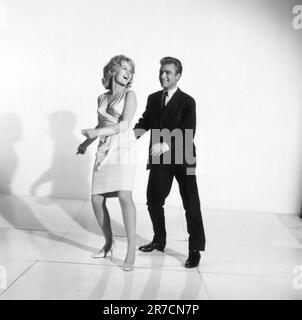 United States:  c. 1961 A photograph of a couple demonstrating how to dance the twist. Stock Photo