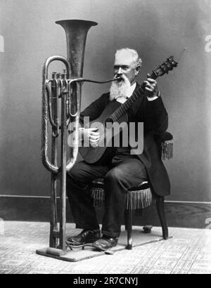 Monterey, California:  c. 1890 Miner, musician and photographer Charles Wallace Jacob Johnson playing his hands free tuba in his one man band. Stock Photo