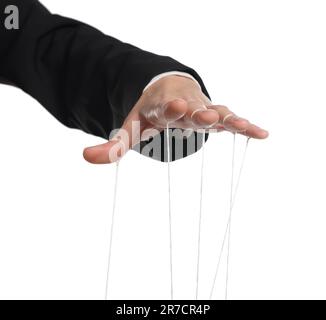 Woman pulling strings of puppet on white background, closeup Stock Photo