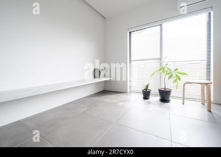 Room with sunlight coming through the blinds Stock Photo