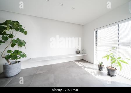 Room with sunlight coming through the blinds Stock Photo