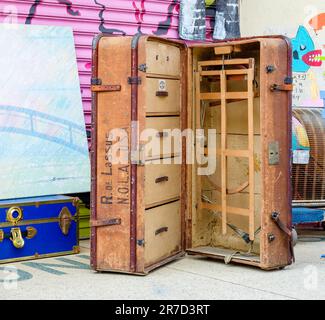 NEW ORLEANS, LA, USA - JUNE 10, 2023: Open antique suitcase on display at flea market Stock Photo