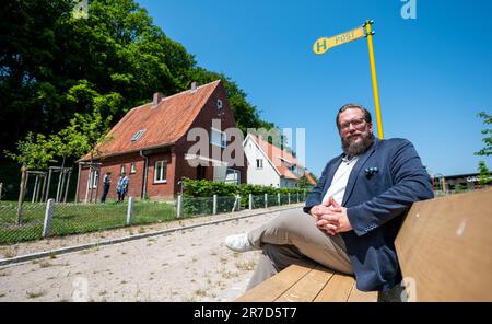 Rosengarten, Germany. 08th June, 2023. Stefan Zimmermann, director of the Open Air Museum at the Kiekeberg sits in front of an original refugee settlement house from 1955. An original refugee settlement house from 1955 at the Kiekeberg Museum shows the needs of displaced persons and challenges of the post-war period. A kitchen garden and a stable for pigs and chickens ensured income. (to dpa 'Displaced people found new home - museum shows life in the 50s') Credit: Philipp Schulze/dpa/Alamy Live News Stock Photo