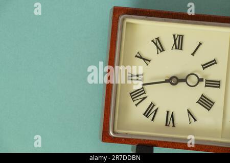 soviet table clock in a wooden frame lie on the table Stock Photo