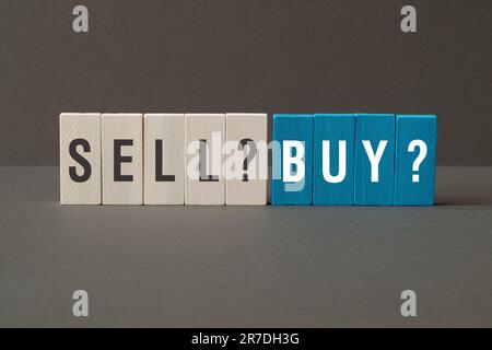 Sell or buy - word concept on building blocks, text, letters Stock Photo