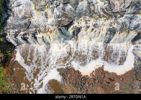 Aerial view of a wide waterfall tumbling into a valley at Warrnambool in Victoria, Australia. Stock Photo