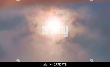 Defocused sunset background over the clouds. Cloudy fog and sun in the center. Stock Photo