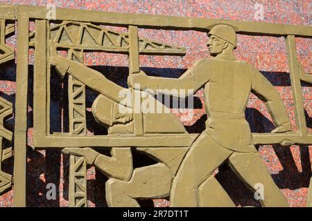 Detail of a panel, showing steel workers. At the Monument of Courage, a Soviet era memorial to the victims of the earthquake of 1966. In Tashkent, Uzb Stock Photo