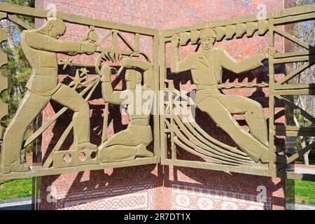 Corner panel, showing electrical, power grid workers. At the Monument of Courage, a Soviet era memorial to the victims of the earthquake of 1966. In T Stock Photo