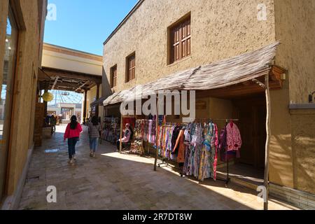 A typical pedestrian shopping street with souvenir stalls. In the recreated, Silk Road era looking village at Anhor park in Tashkent, Uzbekistan. Stock Photo