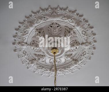 An ornate plaster ceiling rose on a white ceiling in a UK property Stock Photo