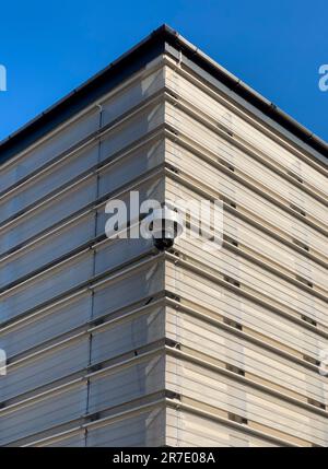 CCTV camera mounted on the exterior corner of a contemporary multstorey car park in the UK. Stock Photo