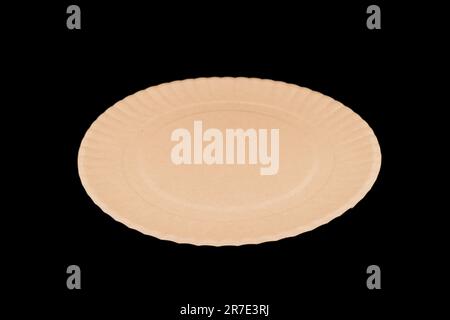 Side view yellow empty disposable paper fast food plate isolated on black background. Stock Photo