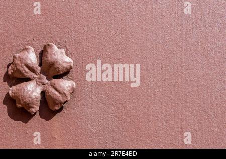 detail of rusty reddish colored steel flower welded on a steel door also rusted by the passage of time. Stock Photo