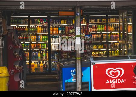 Shop full of branded drinks and foods on shelves and in vending machines with ice in the fridges Stock Photo