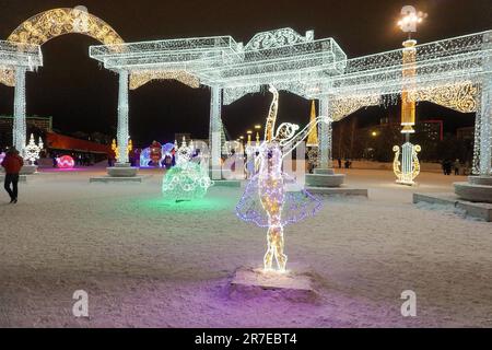 Merry Christmas and Happy New Year! Christmas in the city park. Christmas tree and illumination, luminous figures Stock Photo