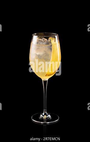 Glass of cold Aperol Spritz cocktail with sliced pineapple isolated on a black background. Fruity frozen alcoholic cocktail. Stock Photo