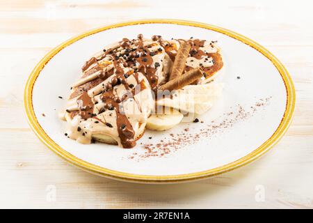 Pancakes with chocolate syrup on white plate. Tasty breakfast. Stock Photo