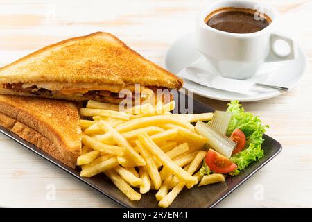 Βreakfast toast with bacon, cheese, pan fried potatoes and cup of coffee. Food background. Stock Photo