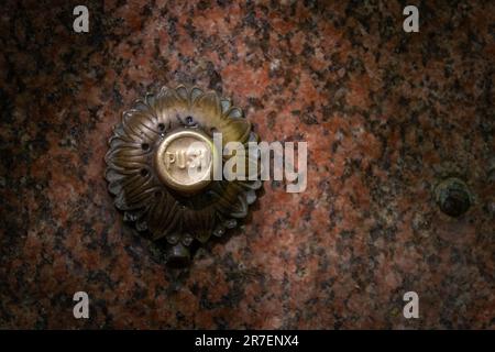 An ornate push button on the front of a nineteenth century drinking fountain in Highgate Woods, London Stock Photo