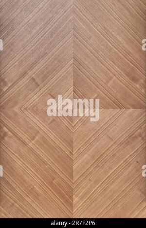 Wall panel of walnut veneer with geometric rhombic pattern as background. Natural materials for interior design. Stylish covering Stock Photo