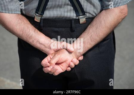 Senior Man  Standing with their Hands Behind their Back Stock Photo