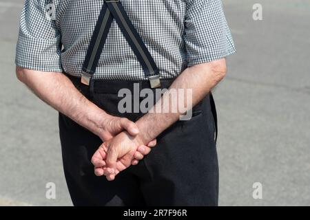 Senior Man  Standing with their Hands Behind their Back Stock Photo