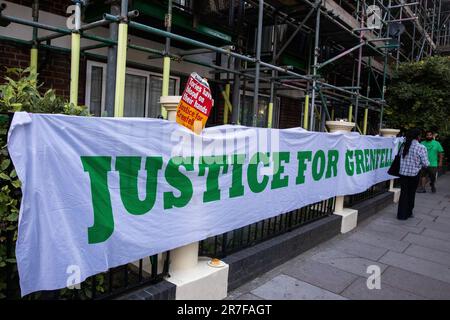 London, UK. 14th June, 2023. A Justice for Grenfell banner is pictured on the route of the Grenfell Silent Walk by members of the Grenfell community around West Kensington. The event was organised to mark the sixth anniversary of the Grenfell Tower fire on 14 June 2017 as a result of which 72 people died and over 70 were injured. The Grenfell Tower Inquiry concluded in November 2022 that all the deaths in the fire were avoidable but no criminal prosecutions have yet been brought. Credit: Mark Kerrison/Alamy Live News Stock Photo