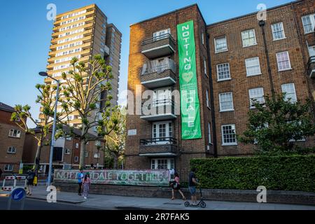 London, UK. 14th June, 2023. A large green banner is pictured hanging from a housing block on the occasion of the Grenfell Silent Walk around West Kensington by members of the Grenfell community. The event was organised to mark the sixth anniversary of the Grenfell Tower fire on 14 June 2017 as a result of which 72 people died and over 70 were injured. The Grenfell Tower Inquiry concluded in November 2022 that all the deaths in the fire were avoidable but no criminal prosecutions have yet been brought. Credit: Mark Kerrison/Alamy Live News Stock Photo