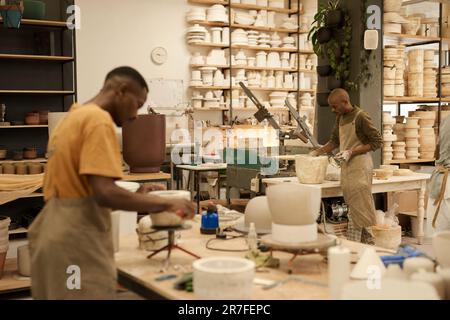 African ceramists working with molds in a pottery workshop Stock Photo ...