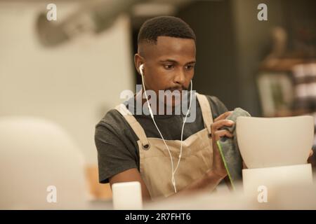 Pan cleaning. Man hand on white background cleaning the non stick pan with  handy dish washing sponge which yellow color on the soft side and green on  Stock Photo - Alamy