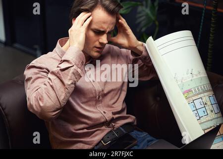 Young architect is suffering from acute tension headache Stock Photo