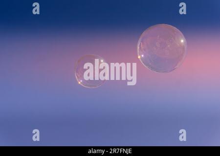 Two soap bubbles against a golden hour sky Stock Photo