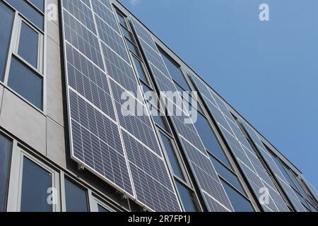 Modern building with solar panels on the wall, facade. Stock Photo