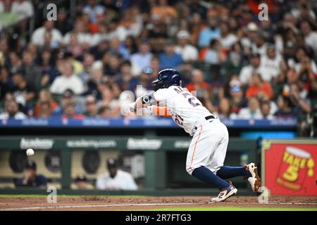 Houston Astros second baseman Jose Altuve (27) bunts in the bottom of the third inning during the MLB game between the Washington Nationals and the Ho Stock Photo