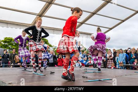 Young girls competing in highland sword dancing event wearing traditional Scottish dress kilts, Highland Games, North Berwick, Scotland, UK Stock Photo