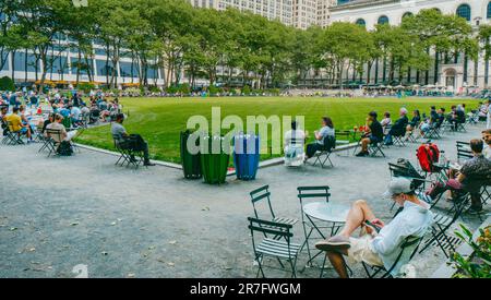 New York City, United States - May 16, 2023: People relaxing at popular Bryant Park, in Midtown Manhattan, New York City, United States, on a sunny sp Stock Photo