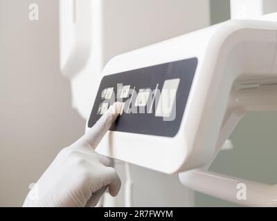 Young female dentist finger with a latex glove preparing materials before surgery Stock Photo